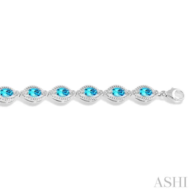 1/10 Ctw Round Cut Diamond & 6x4MM Oval Cut Blue Topaz Semi Precious Bracelet in Sterling Silver