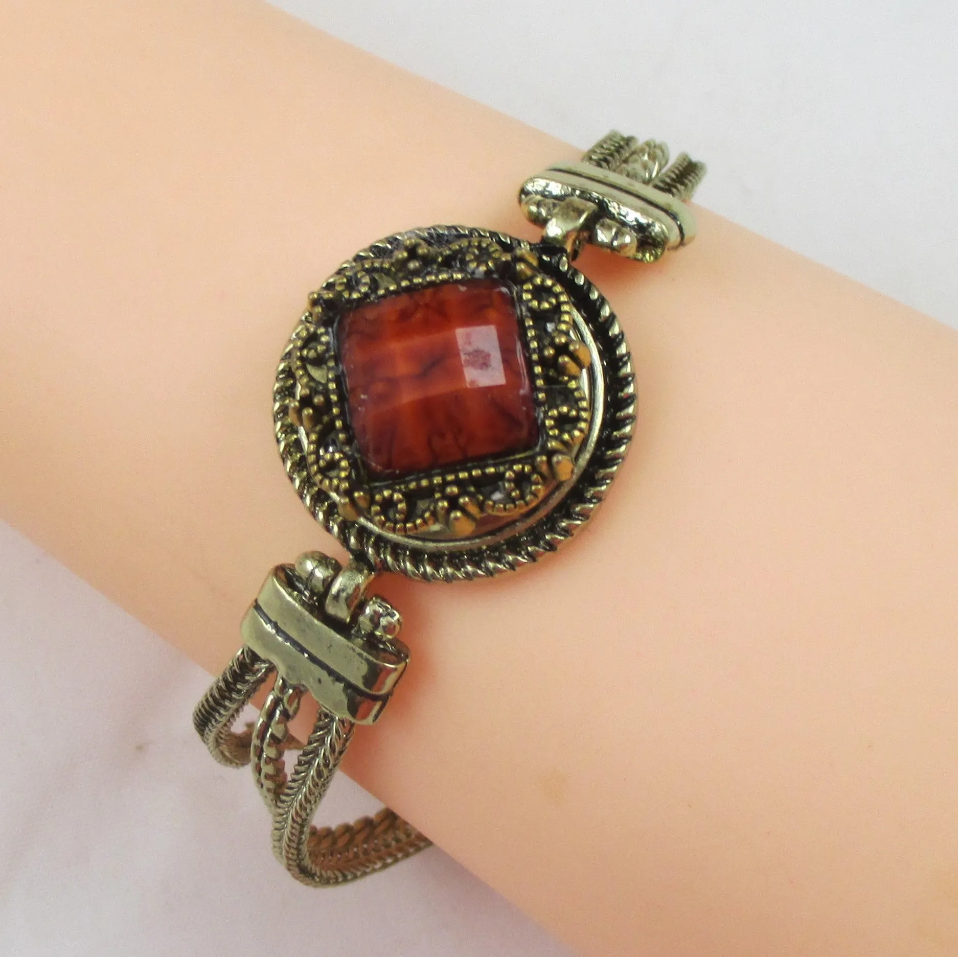 Dark Orange Crystal on a  Antique Gold Bangle Bracelet